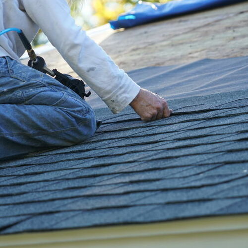 A Roofer Repairs Shingles.
