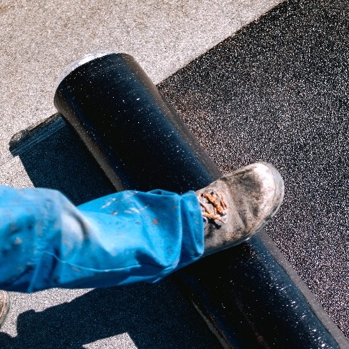 A Roofer Installs Modified Bitumen.