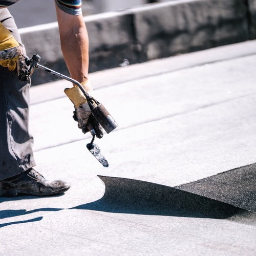 Roofer at Work on a Commercial Roof