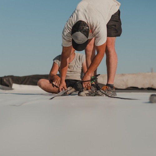 Commercial Roofer Installs Roofing.