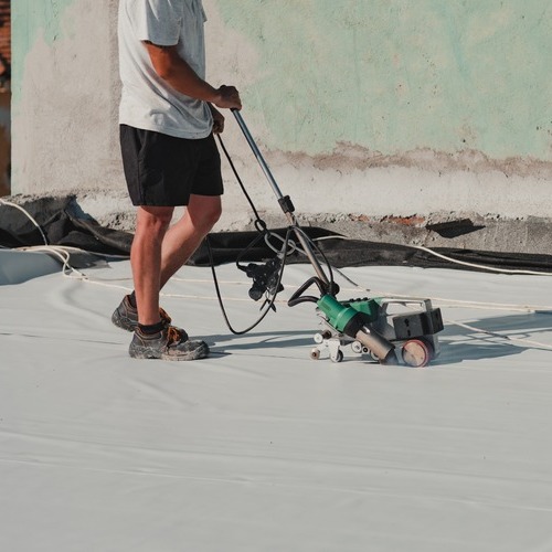 A Commercial Roofer Applies TPO.