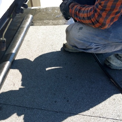 A Commercial Roofer Works on Single-Ply Roofing.
