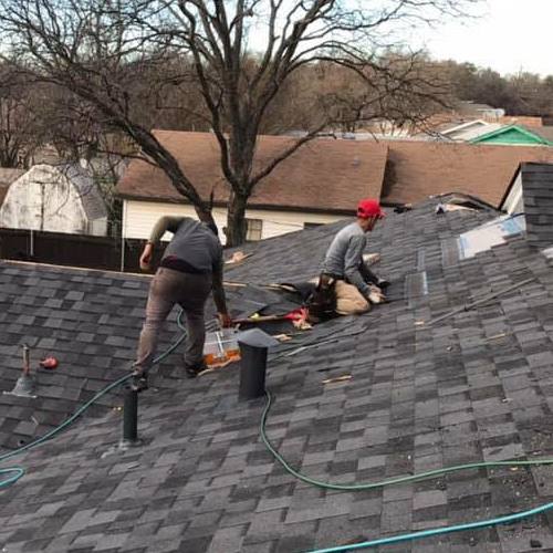 Roofers Work on a Roof.