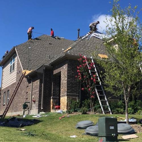 Roofers Work on an Asphalt Shingle Roof.