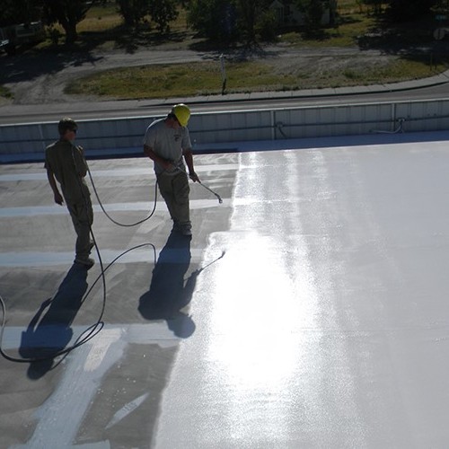 Roofers Apply a Flat Roof Coating.