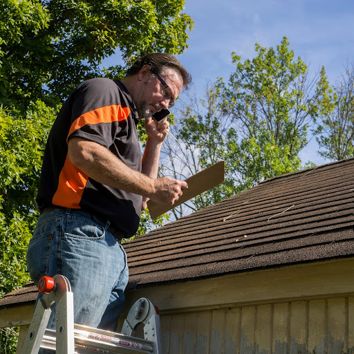 An Insurance Adjusted Inspects a Roof.