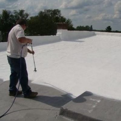 A Contractor Applies a Flat Roof Coating.