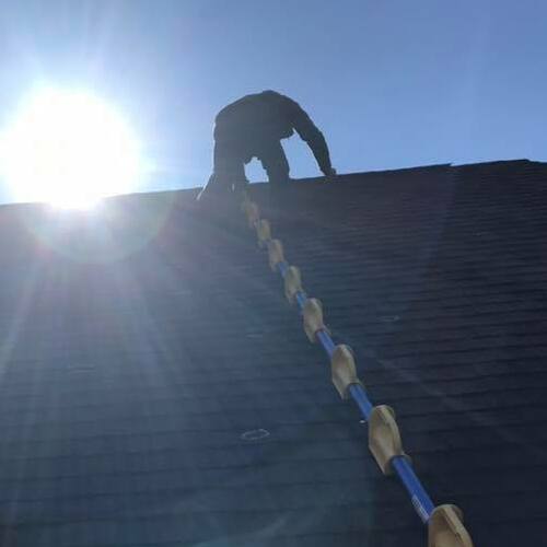 A Roofer Inspects a Roof.