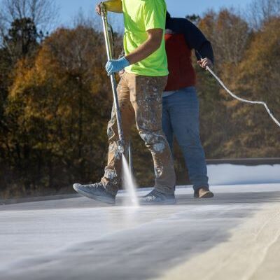 Roofers Apply a Roof Coating.