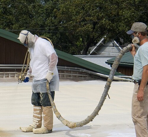 Roofer Sprays Foam Roofing.